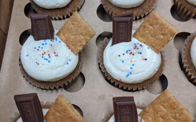 Several s'mores cupcakes arranged in a baking tin.