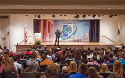 Keynote speaker presenting attendees at the 4-National Conference.
