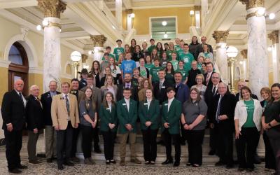 4-H Capitol Day participants stand at the S.D. Capitol building steps with S.D. Senators and Representatives and university personnel.