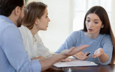 Young couple discussing a concern with a distressed small business team member.