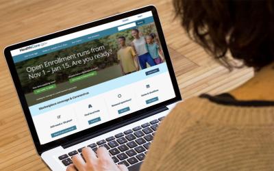 Woman navigating Health Insurance Marketplace on laptop.