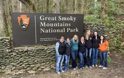 Group of Collegiate 4-H members standing in front of Great Smoky Mountains National Park sign