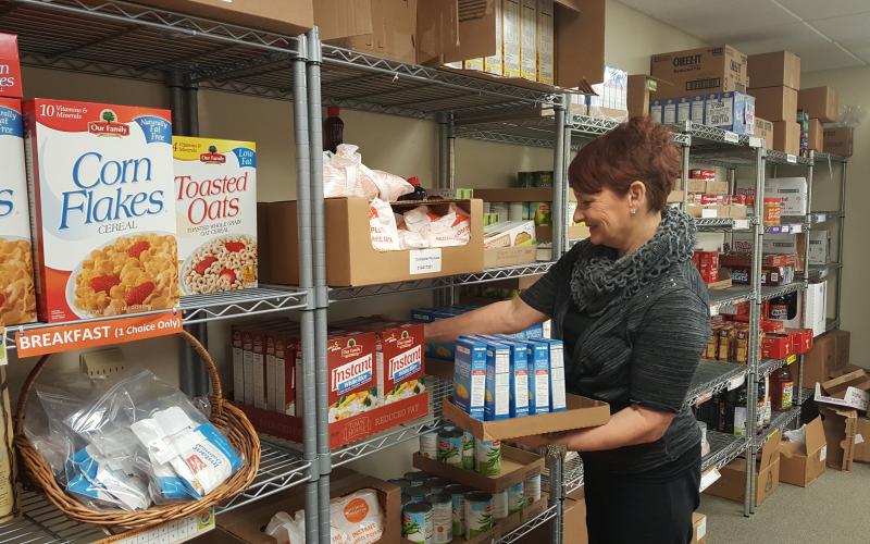 woman stocking shelves in a food pantry