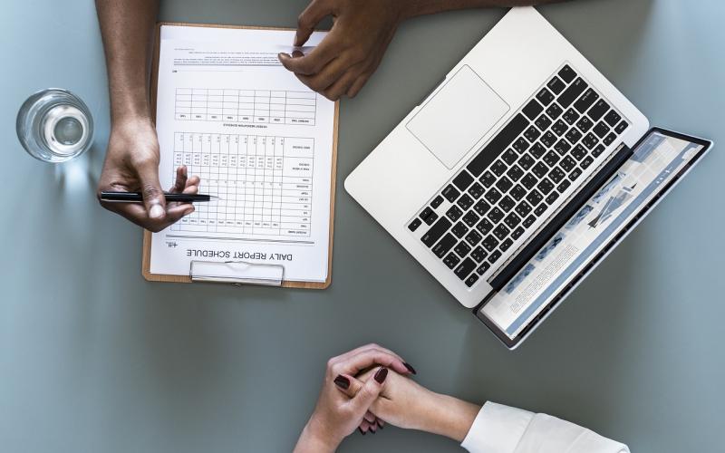 Pair of hands at a desk during a health consultation.