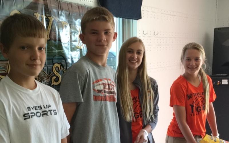 Youth working a fruit and yogurt snack table