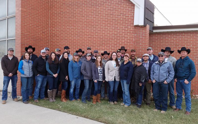 image of a group of farmers and ranchers in front of a brick building