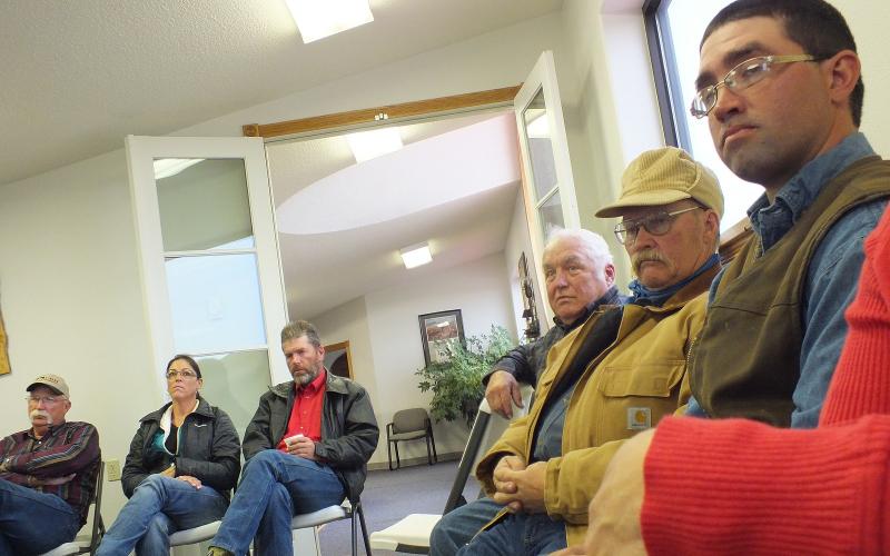 A group of farmers and ranchers sitting at a meeting