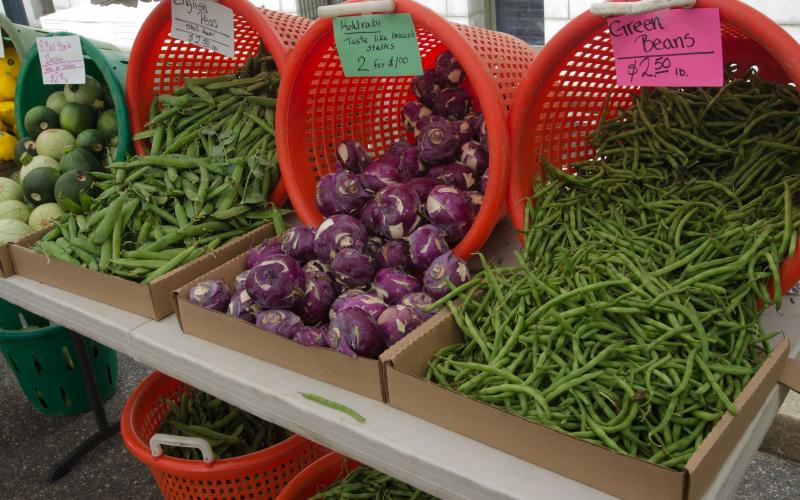 Baskets of fresh vegetables at a farmers market