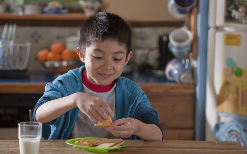 child enjoying whole wheat crackers and cheese