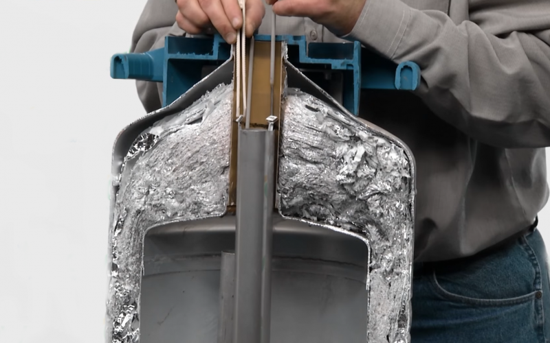 semen straw being thawed in a liquid nitrogen tank