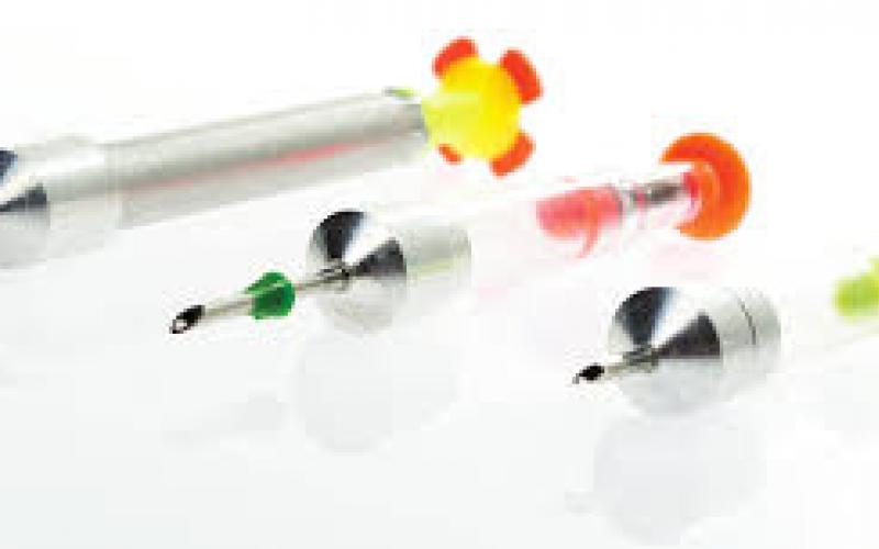 Three cattle injection needles.