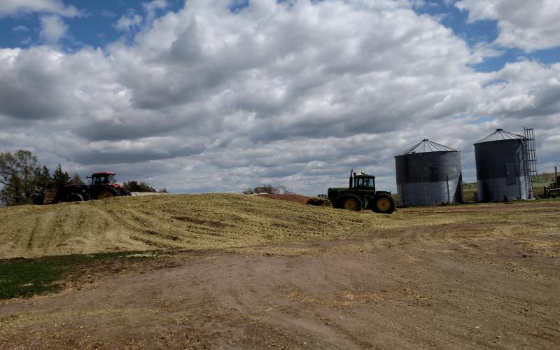 tractor near pile of harvested silage