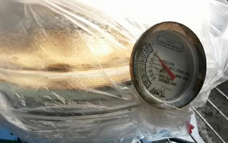 food thermometer being callibrated in oven