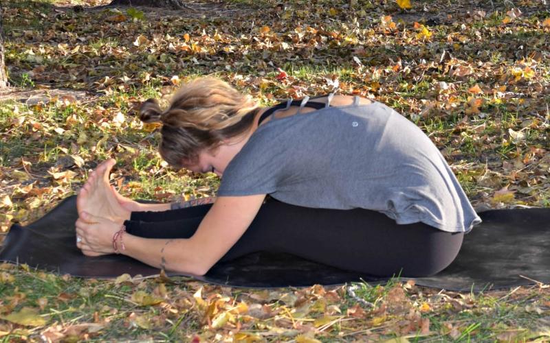 Young woman demonstrating seated forward bend