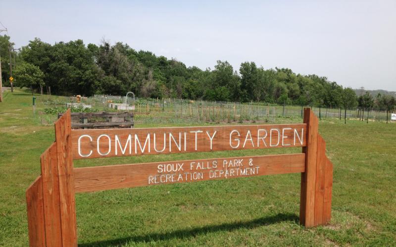 a wooden sign for a community garden