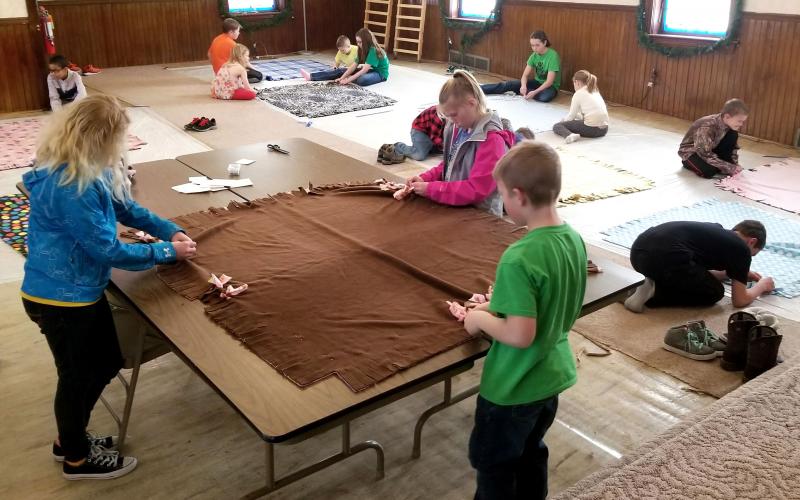 group of 4-H youth participating in a blanket-making workshop