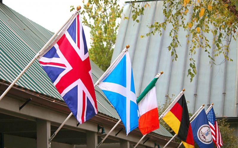 various international flags displayed at an outdoor pavilion