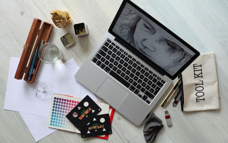 laptop computer and various design tools sitting on a desk