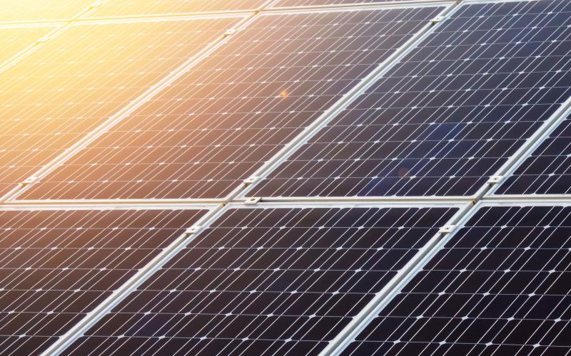 a solar panel with sunlight reflecting off it