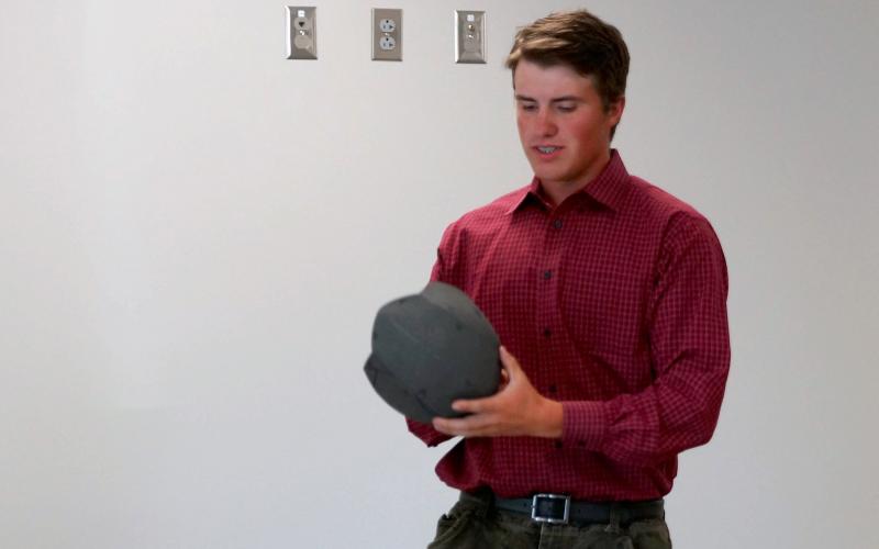male youth giving a how-to demonstration