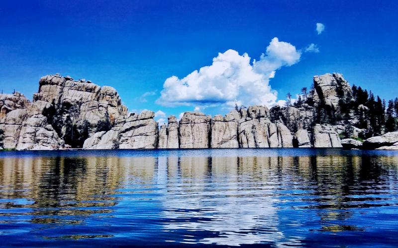granite rock formation surrounding a lake.