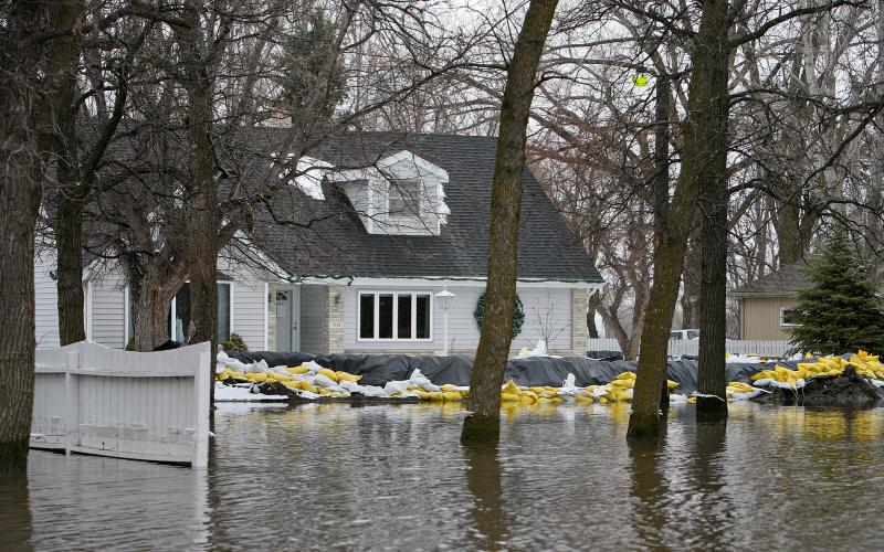 Sand Bagged home in surrounded by flood water. FEMA News Photo