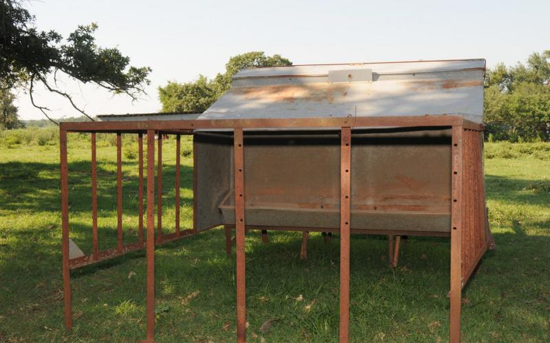 a creep feeder unit in a pasture. Photo by Alice Welch, USDA