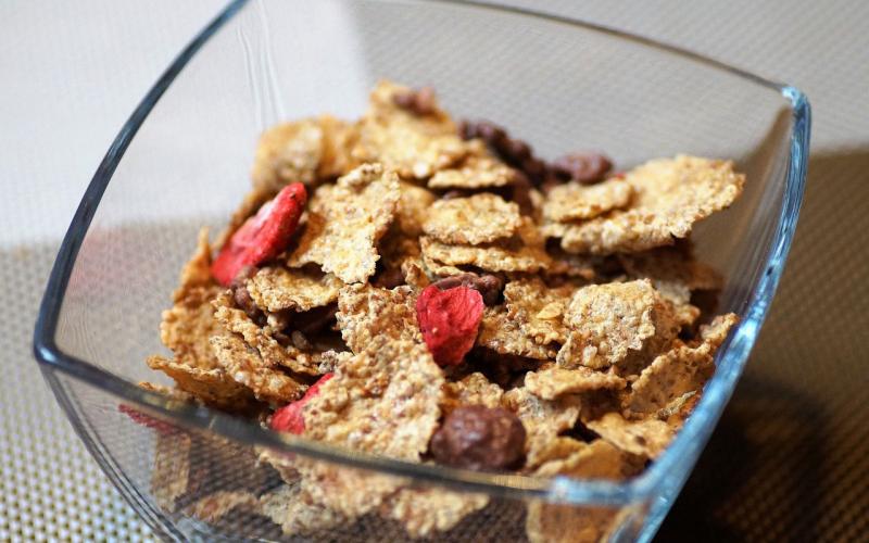 A bowl of iron-fortified breakfast cereal mixed with pices of dried fruit.