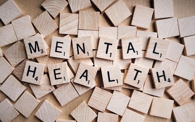 scrabble tiles arranged to spell mental health