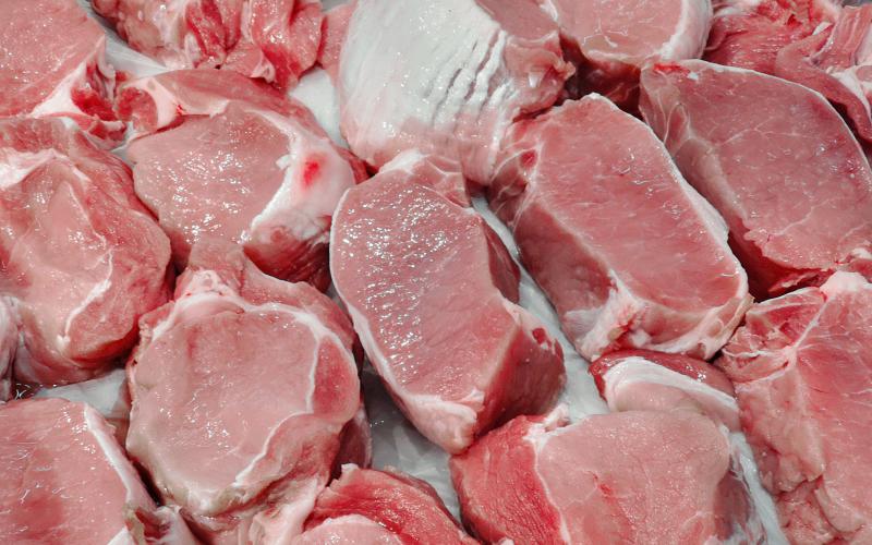 Various cuts of raw pork ready for packaging.