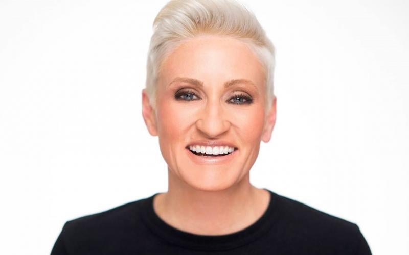a smiling woman with a black shirt