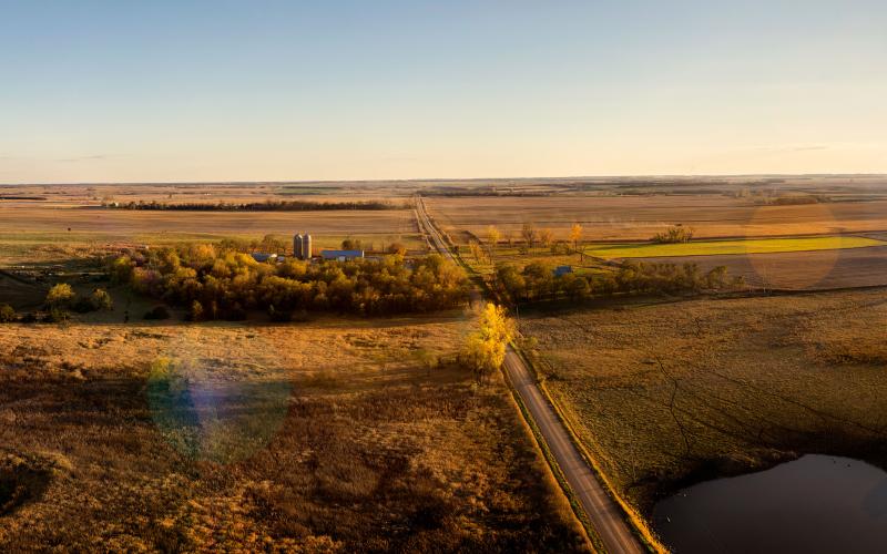 South Dakota agricultural landscape painted with Spring colors and a setting Sun.