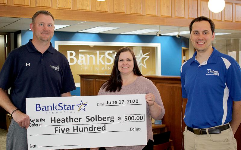 two men and one woman standing with a presentation check