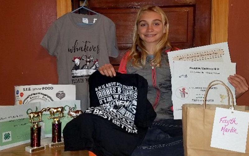 Fayth Martin posing with her many 4-H awards.
