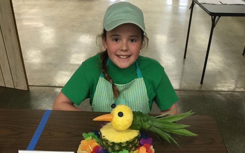 Hope Baysinger presenting a special foods project at a table.
