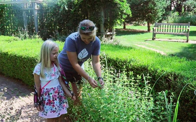 Mother and daughter examining plant at McCrory Gardens.