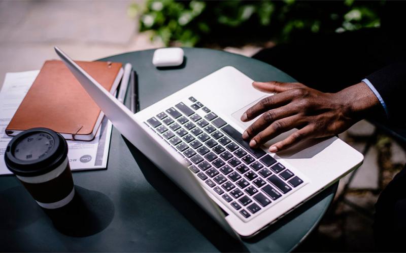 Young, african american male using laptop computer.