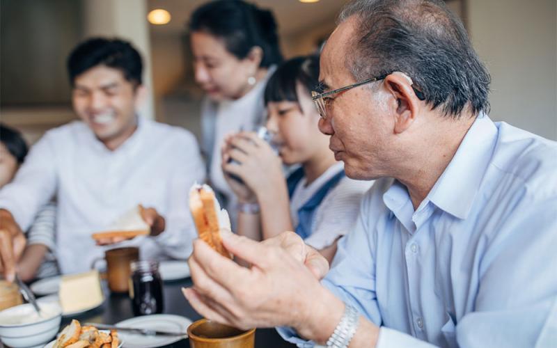 Asian family sharing a holiday meal together.
