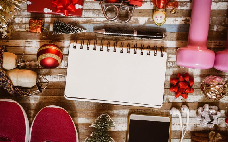 Holiday decorations and fitness equipment arranged on a tabletop.