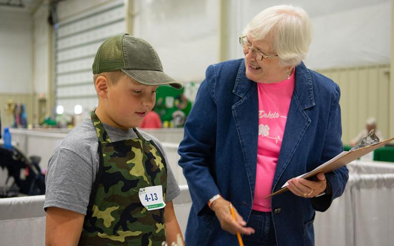 4-H volunteer talking to a 4-H youth.