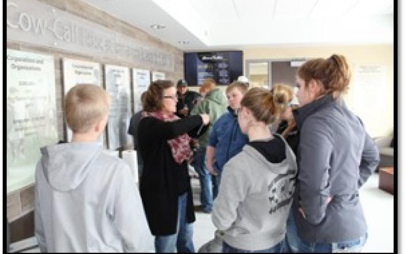 several youth standing in front of a few billboards