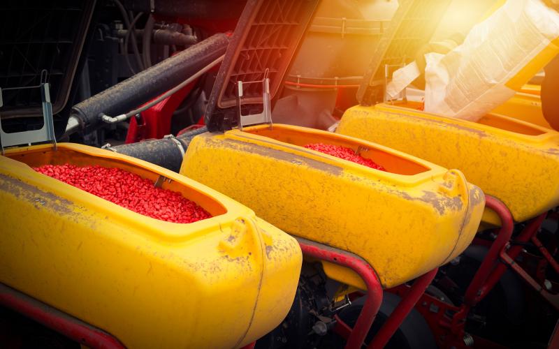 Hybrid corn seeds being loaded into a planter.