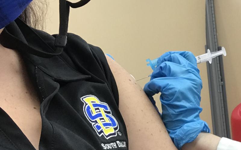 a woman receiving a shot