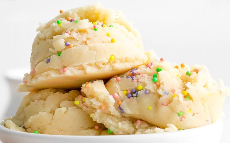 Scoops of ready-to-eat cookie dough in a white bowl.