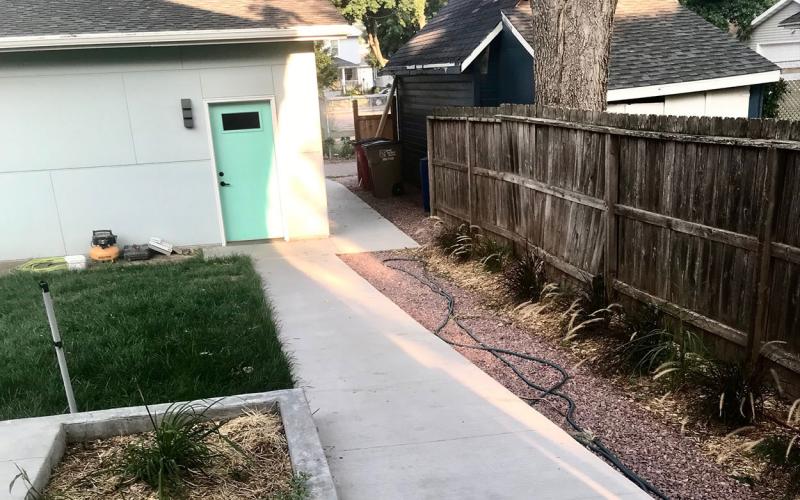 Rear, no-step entrance of a modern, adaptable home with a level walkway.