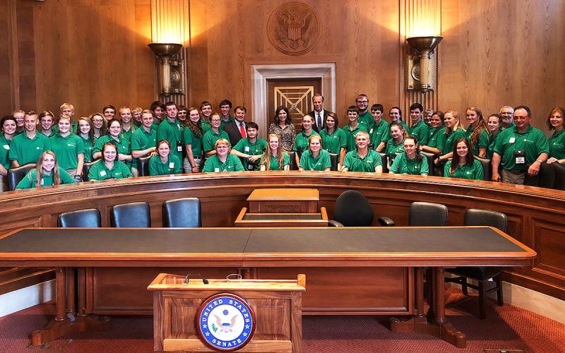 Citizenship Washington Focus delegates and chaperones in the U.S. Senate Chamber with Senators John Thune and Mike Rounds and Governor Kristi Noem.