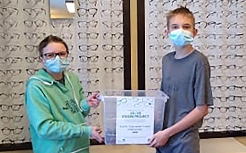 Atty Eastman, Jonathan Burleson and Joshua Burleson collecting glasses at an eye clinic for the South Dakota 4-H "20/20 Vision" community service project.