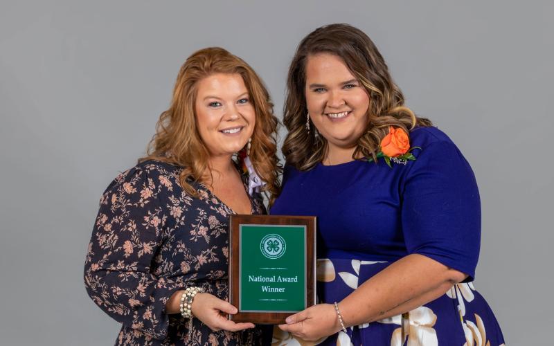 Hilary Risner and Caroline Hansen accepting the Citizenship in 4-H Youth Development national award.