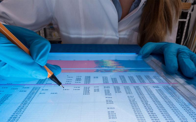 Young, female scientist analyzing genetic code in a laboratory.