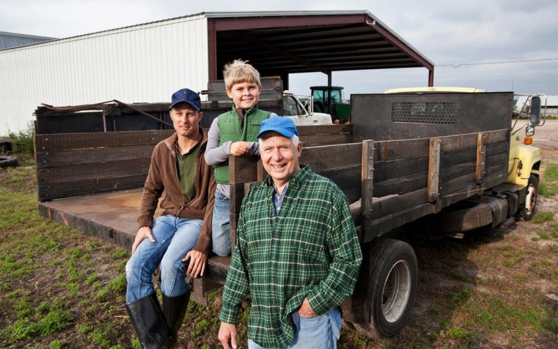 Three generations of men on the family farm.